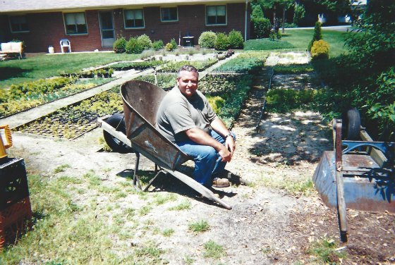 Mike McGroarty taking a break in a wheelbarrow.