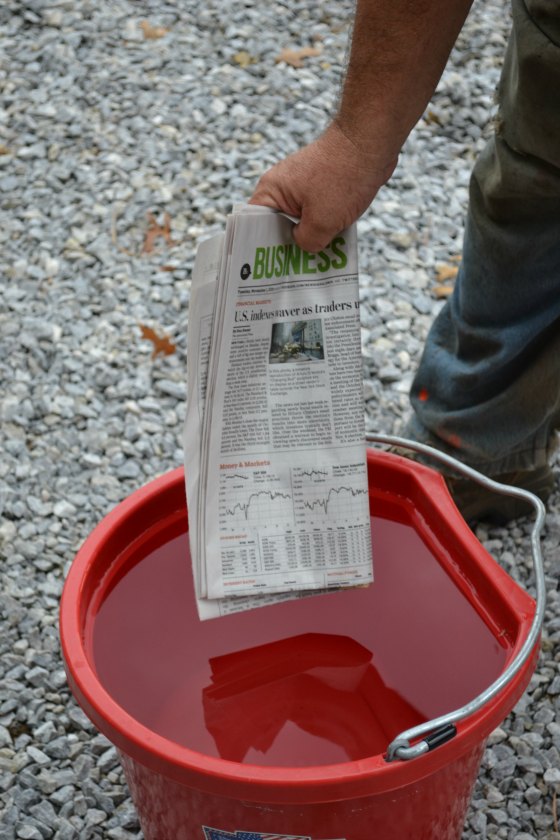 Dip several sections of newspaper in a bucket of water.